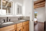 En-suite bathroom with double sinks and bright lighting